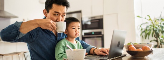 Father Drinking Coffee with Son on his Lap