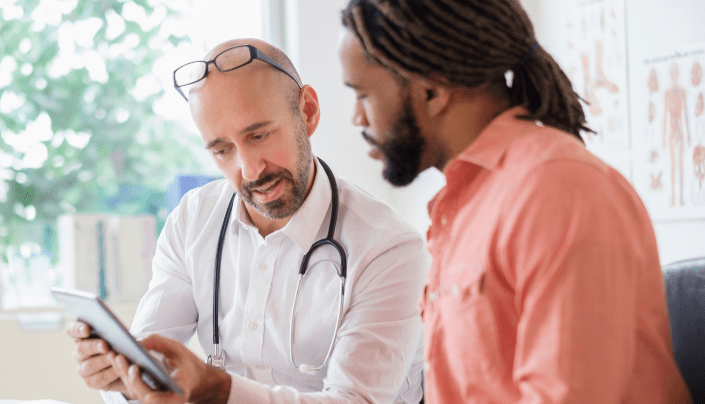 Doctor and Patient Looking at Tablet