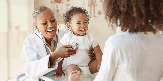 Doctor listening to baby's heart with stethoscope